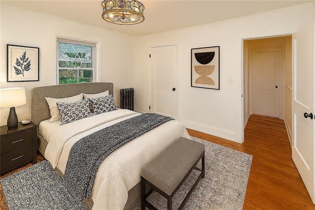 1423 Chislett Street Pittsburgh, PA 15206 - Photo 16 of 47 a bedroom with bed and wooden floor