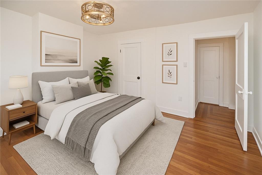 1423 Chislett Street Pittsburgh, PA 15206 - Photo 17 of 47 a bedroom with a bed and a chandelier