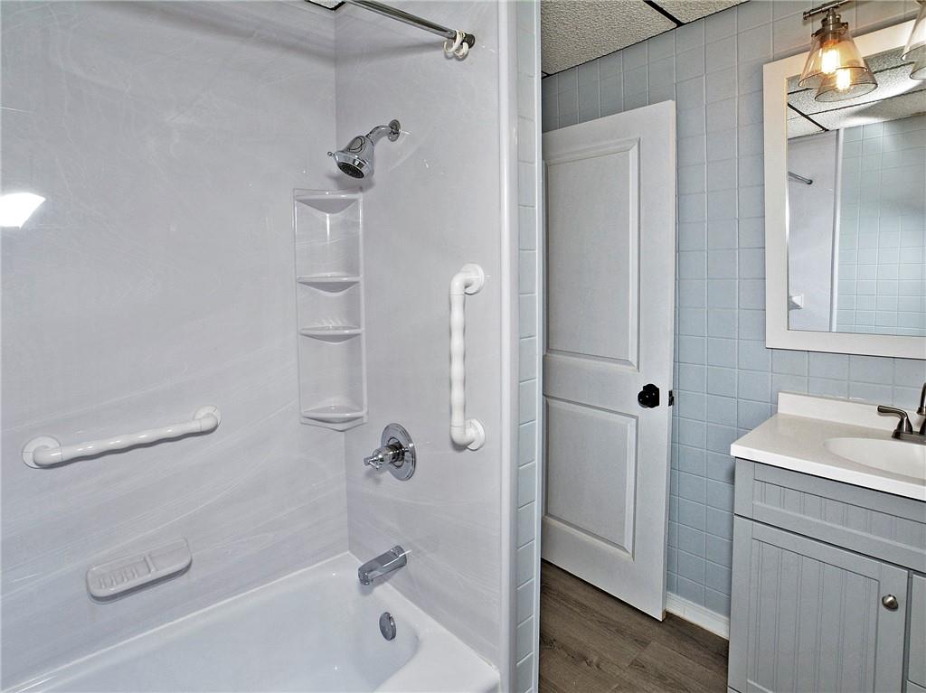 1423 Chislett Street Pittsburgh, PA 15206 - Photo 18 of 47 a bathroom with a sink a mirror and a bathtub