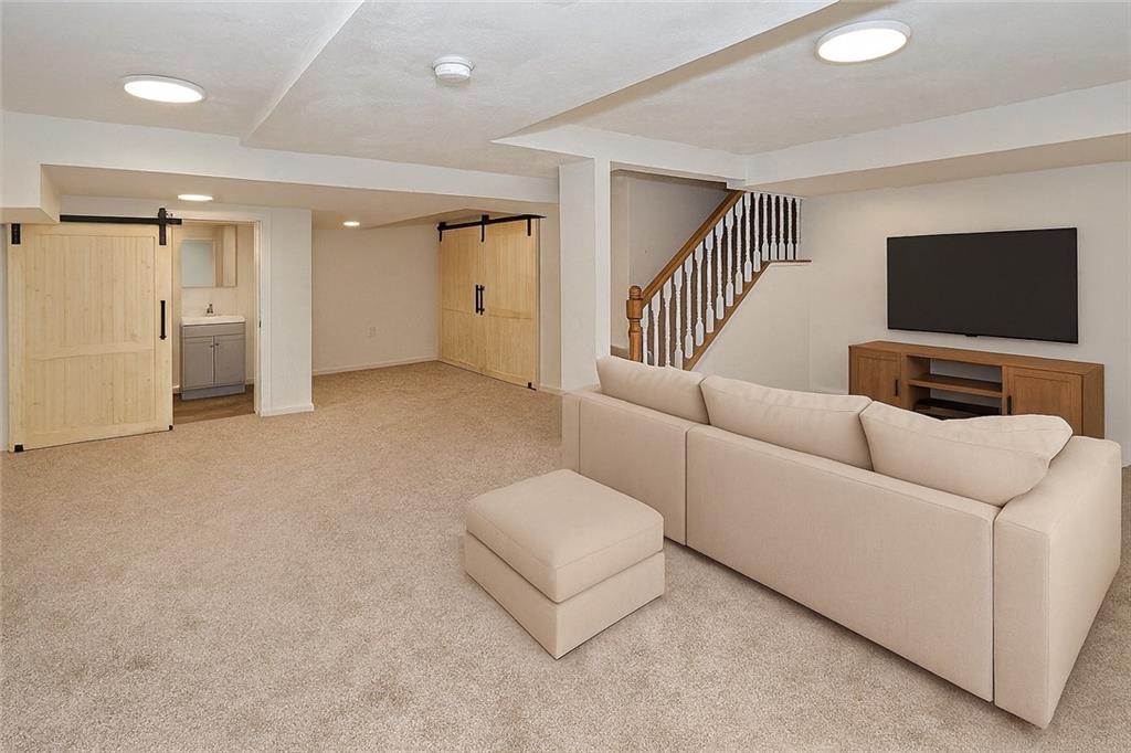 1423 Chislett Street Pittsburgh, PA 15206 - Photo 24 of 47 a living room with furniture and a flat screen tv