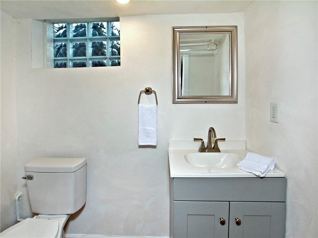 1423 Chislett Street Pittsburgh, PA 15206 - Photo 25 of 47 a bathroom with a sink mirror and toilet