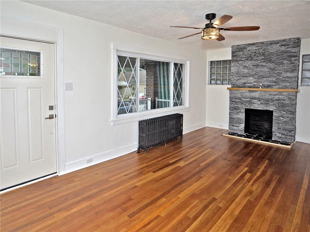 1423 Chislett Street Pittsburgh, PA 15206 - Photo 30 of 47 a view of empty room with wooden floor and fireplace