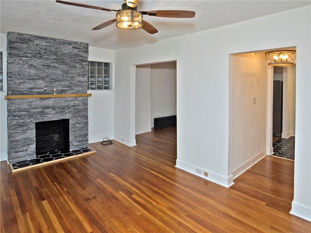 1423 Chislett Street Pittsburgh, PA 15206 - Photo 31 of 47 a view of an empty room with wooden floor fireplace and a window