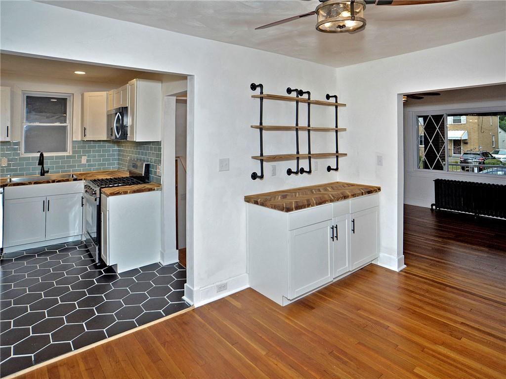 1423 Chislett Street Pittsburgh, PA 15206 - Photo 32 of 47 a kitchen with a sink stove and cabinets