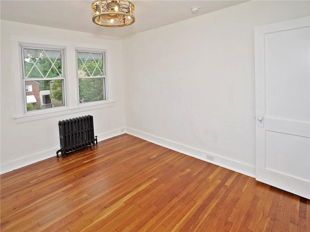 1423 Chislett Street Pittsburgh, PA 15206 - Photo 33 of 47 an empty room with wooden floor and windows