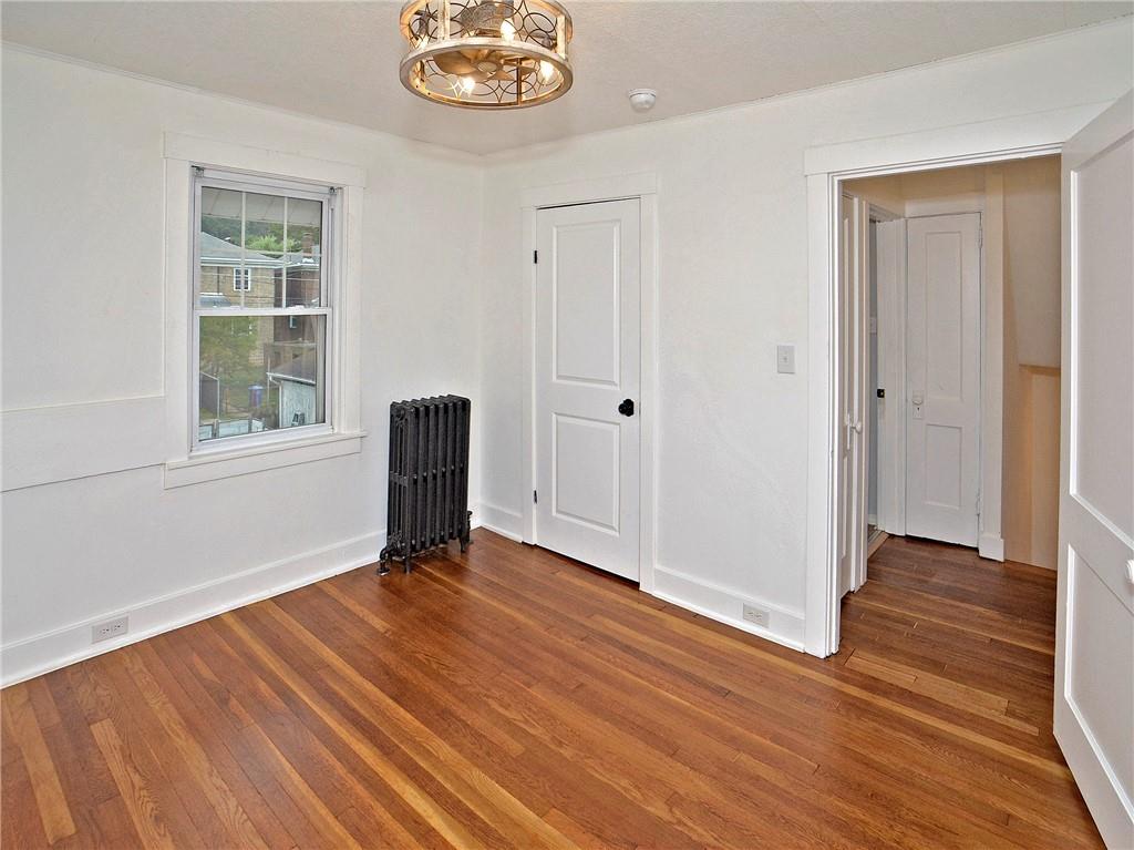 1423 Chislett Street Pittsburgh, PA 15206 - Photo 38 of 47 an empty room with wooden floor and windows