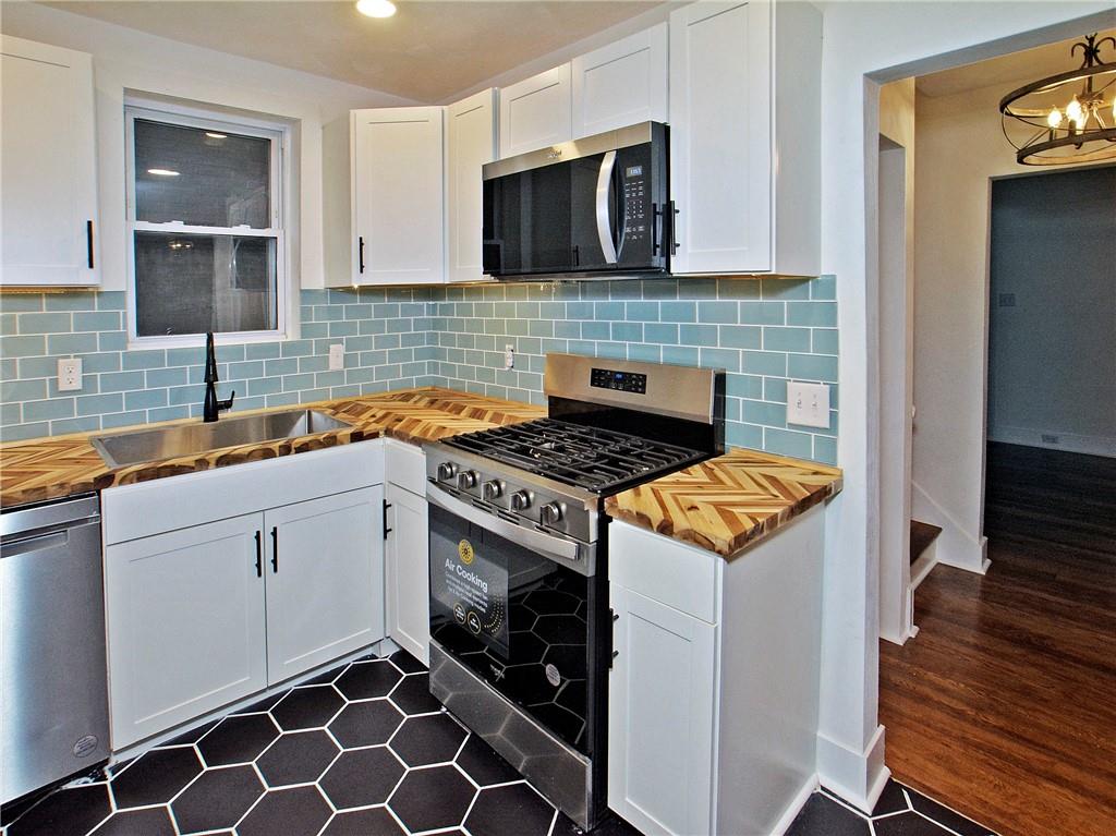 1423 Chislett Street Pittsburgh, PA 15206 - Photo 8 of 47 a kitchen with sink cabinets and stove