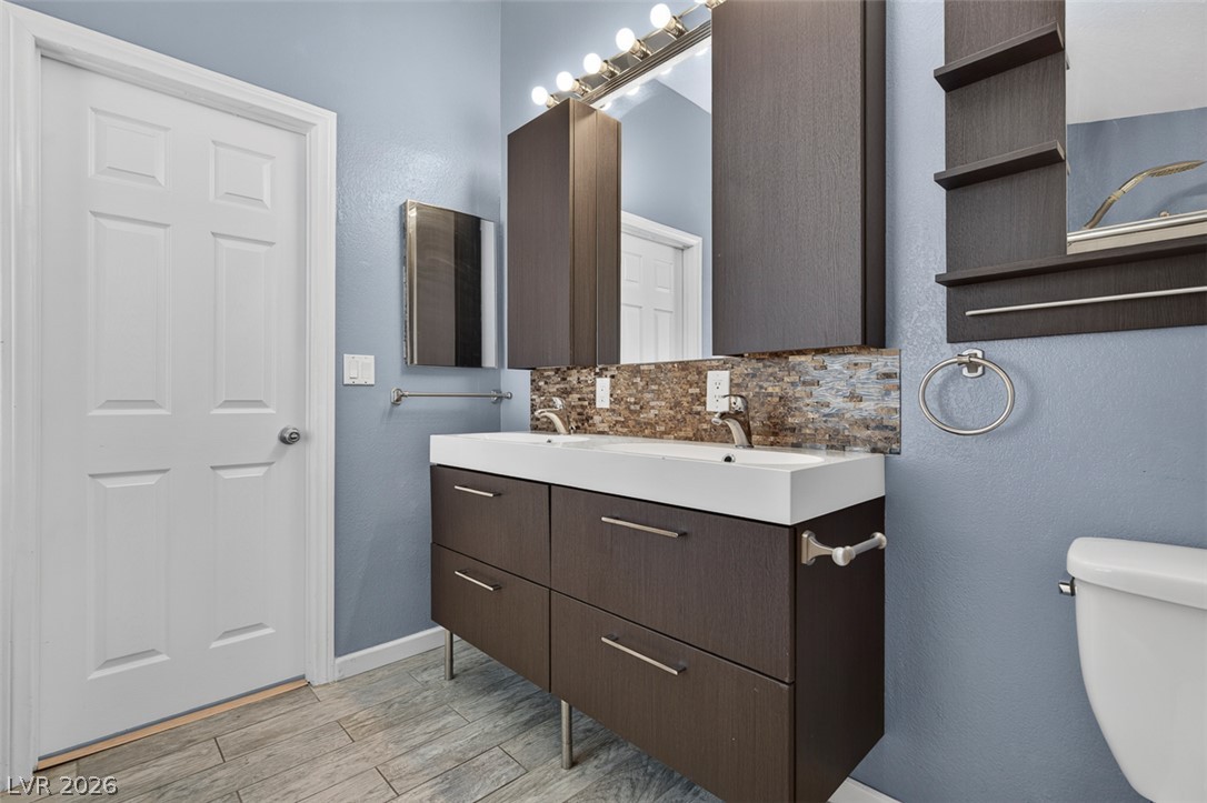2609 Shakespeare Road Las Vegas, NV 89108 - Photo 22 of 41 A well-appointed bathroom features a contemporary double vanity and stylish tile flooring.