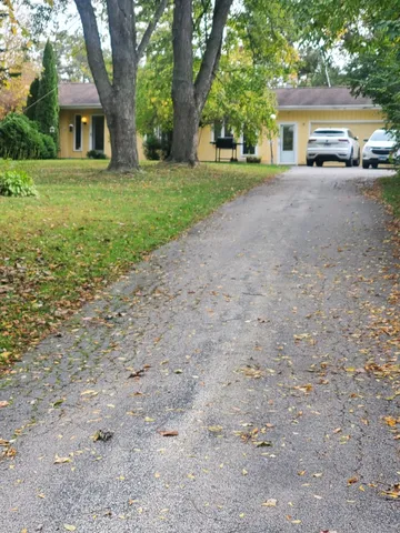 a front view of a house with a yard and a garage