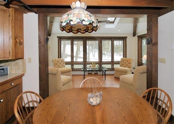 38 Ridge Road Tolland, MA 01034 - Photo 12 of 21 a view of a dining room with furniture a chandelier and large windows