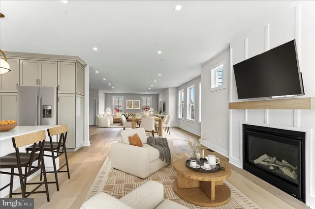 a living room with furniture a fireplace and flat screen tv