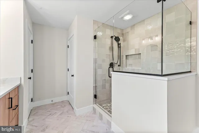 a bathroom with a shower and a sink
