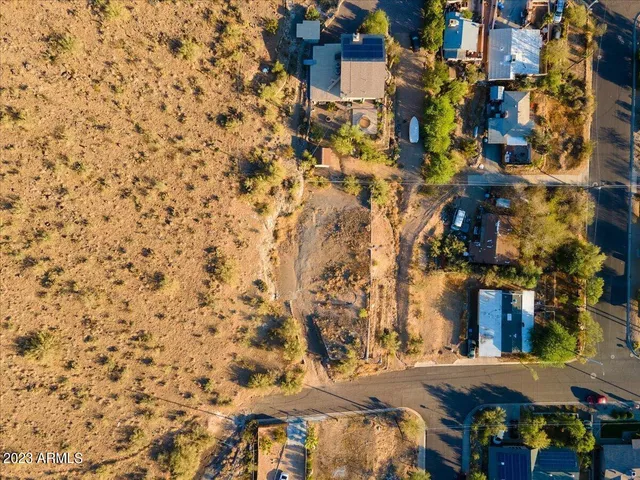 an aerial view of residential houses with city view