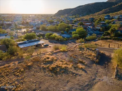 an aerial view of residential houses with outdoor space and trees