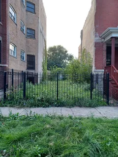 a garden is sitting in front of a brick building