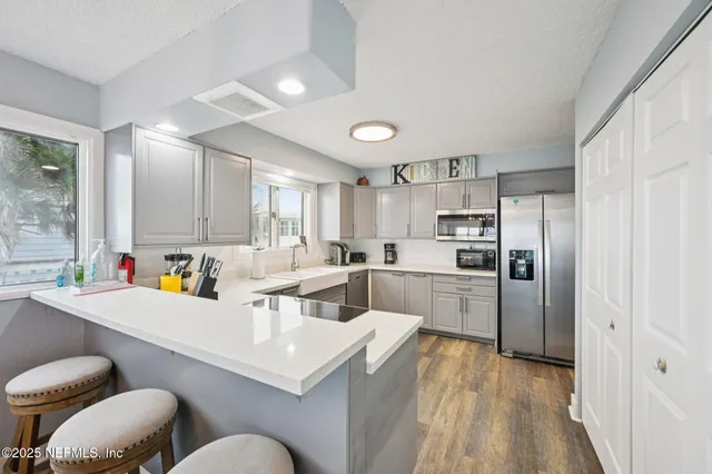 a bedroom with a bed wooden floor and window