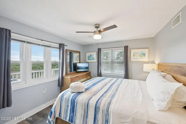 a bedroom with a large bed and a large window