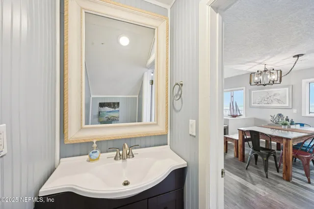 a bathroom with a sink a toilet and mirror