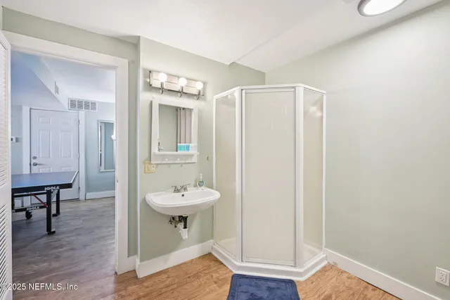 a view of a big house with a big yard and large trees