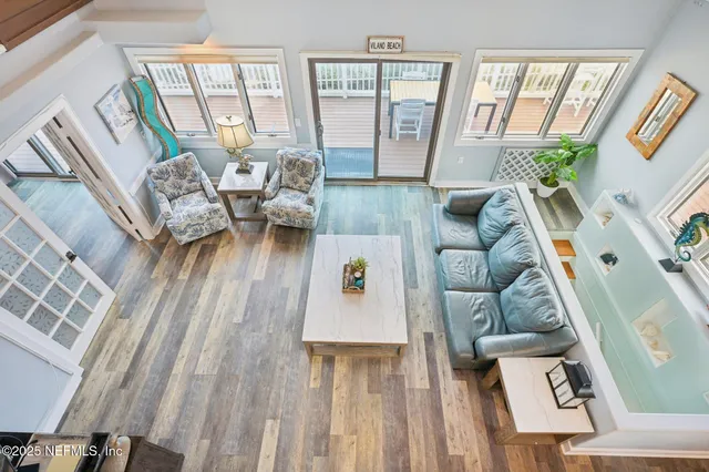 a view of a dining room with furniture wooden floor and chandelier