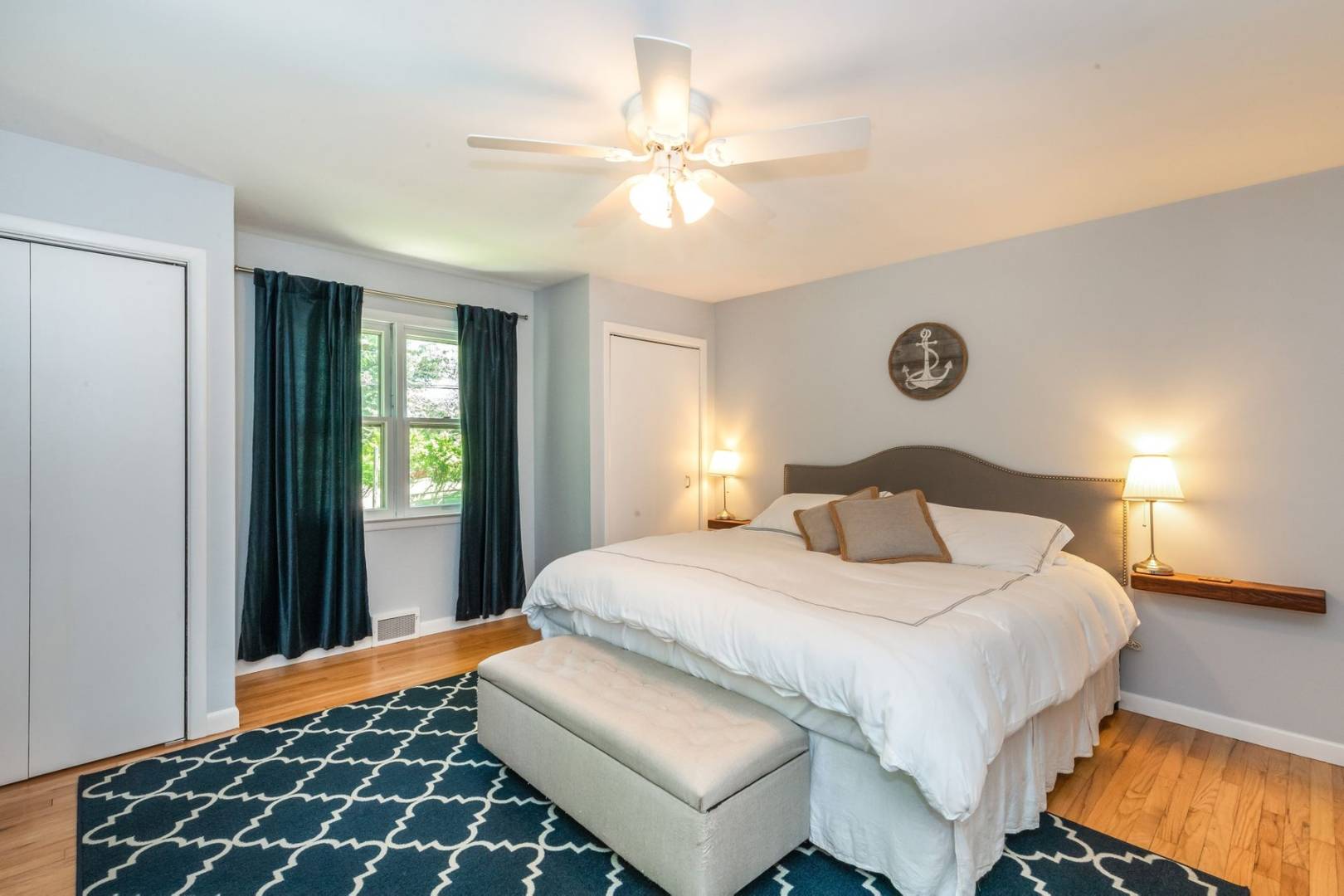 8 Bruce Lane East Hampton, NY 11937 - Photo 11 of 13 a bedroom with a bed and a chandelier