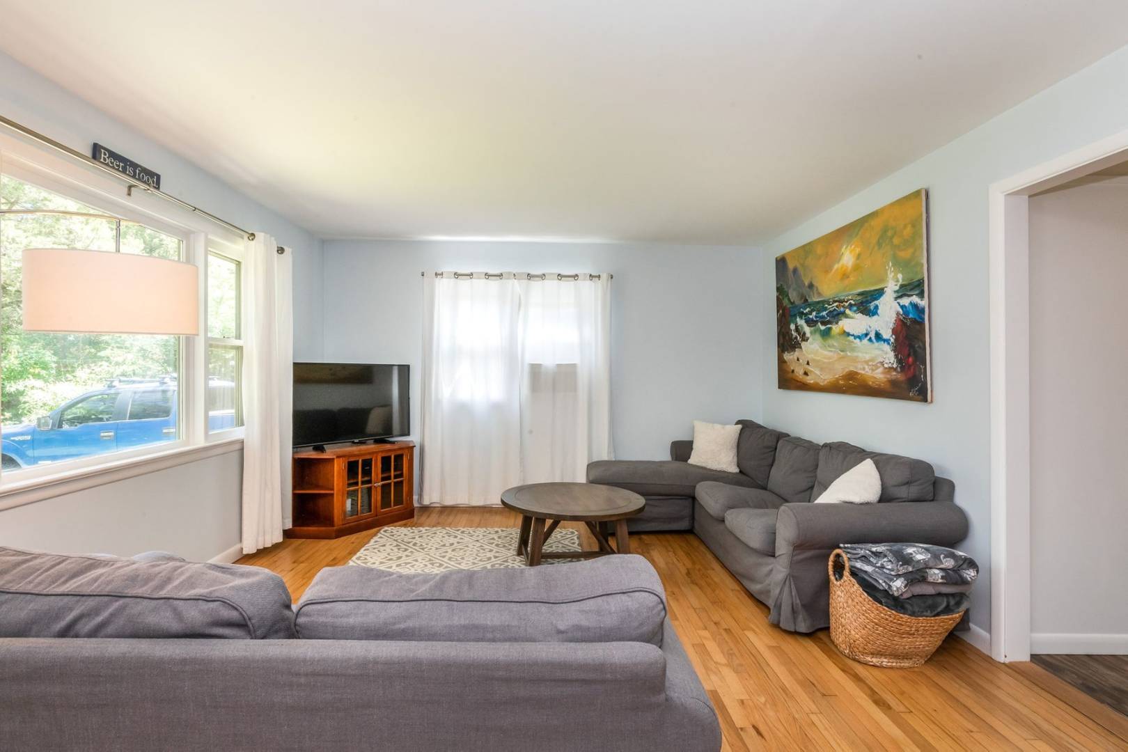 8 Bruce Lane East Hampton, NY 11937 - Photo 6 of 13 a living room with furniture a flat screen tv and a large window