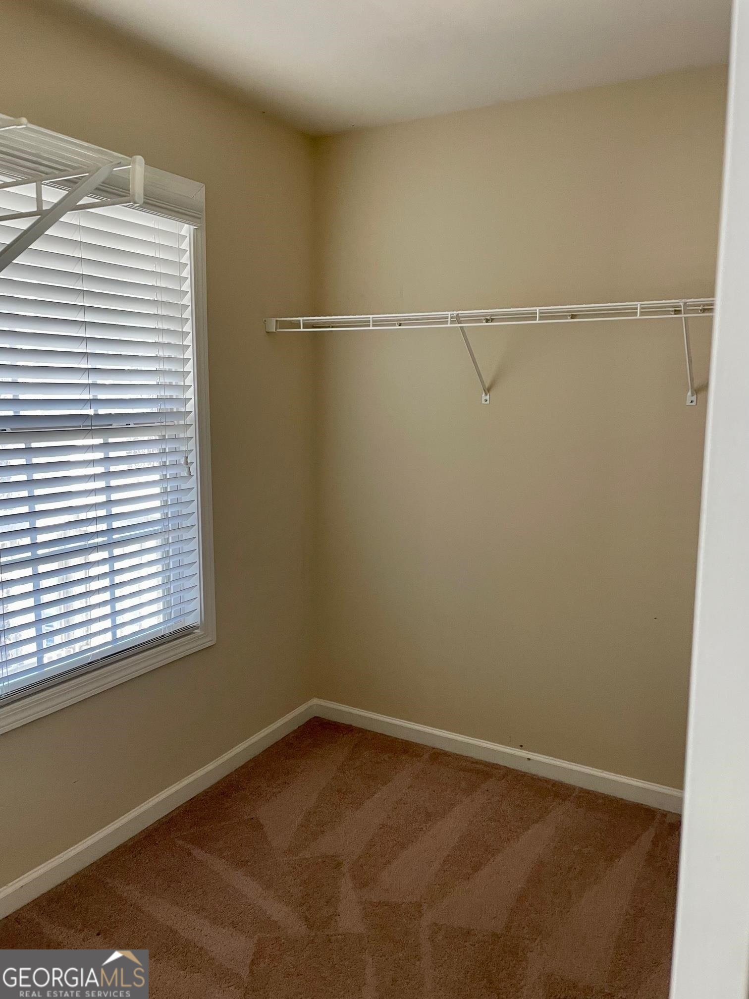 5371 Apple Grove Road Northeast Buford, GA 30519 - Photo 11 of 17 a view of a room with racks on the wall