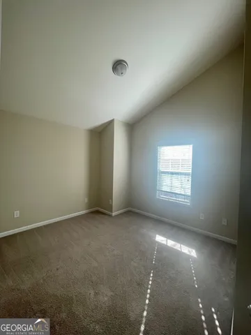 an empty room with a empty space and windows