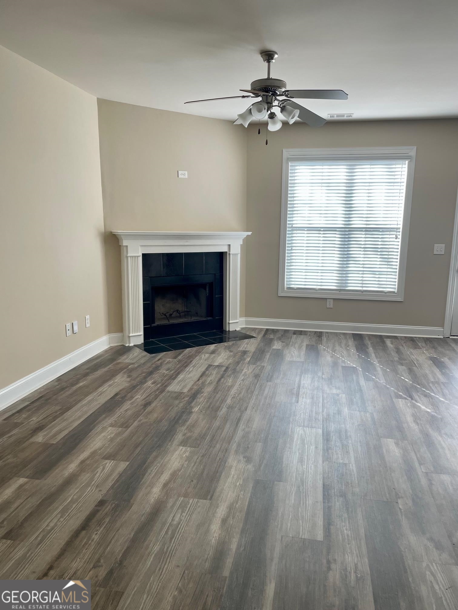 5371 Apple Grove Road Northeast Buford, GA 30519 - Photo 2 of 17 wooden floor fireplace and windows in an empty room