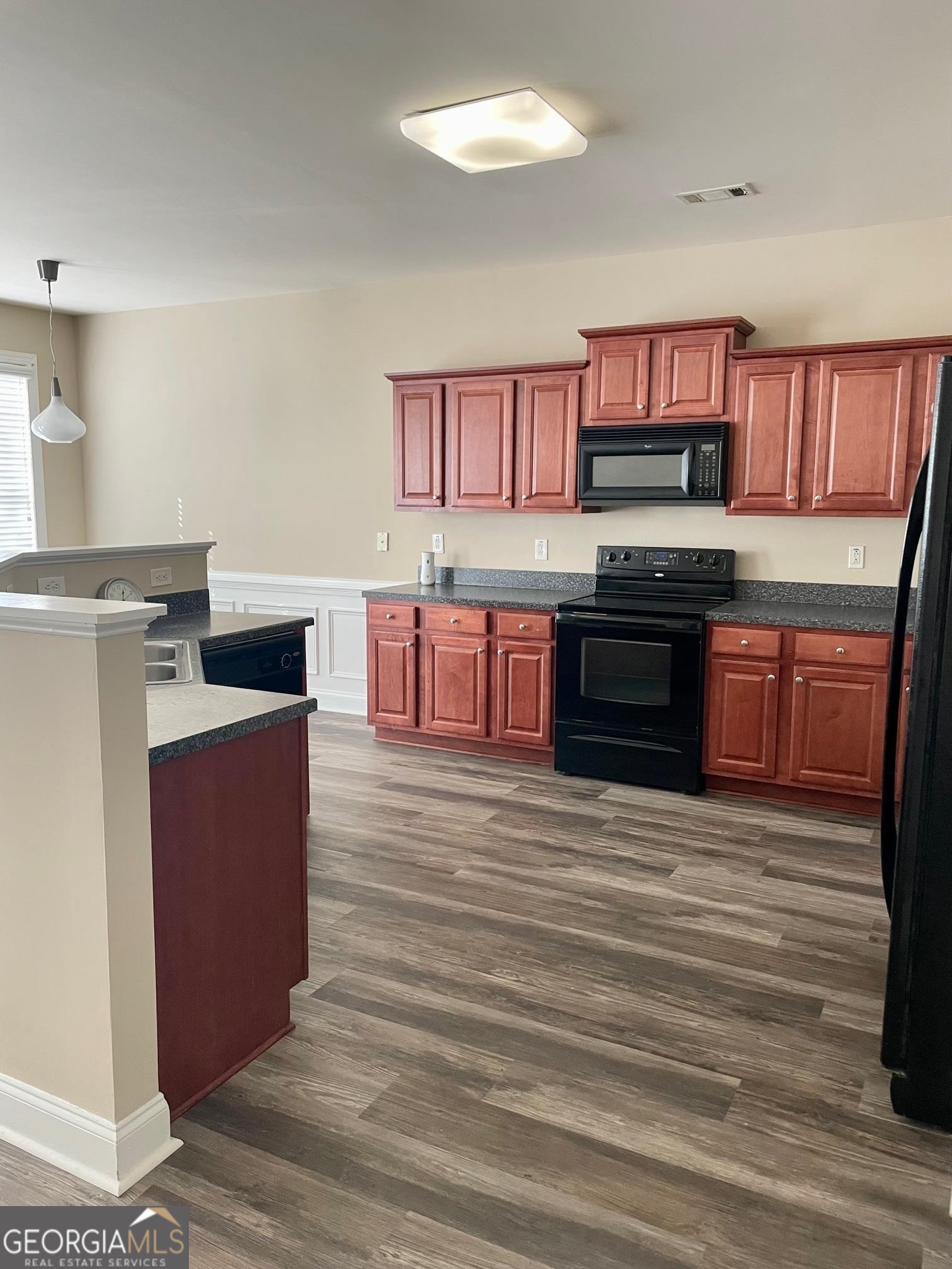 5371 Apple Grove Road Northeast Buford, GA 30519 - Photo 3 of 17 a kitchen with stainless steel appliances granite countertop a stove a sink and a refrigerator