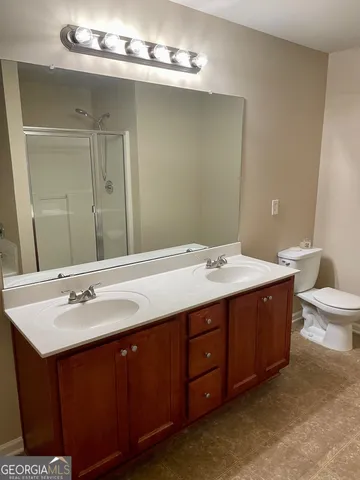 a bathroom with a double vanity sink and a mirror