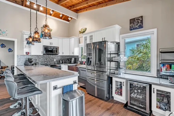 a kitchen with granite countertop a sink and a stove top oven
