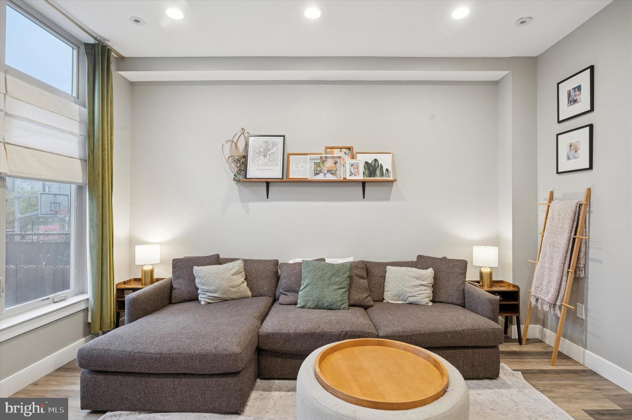 1942 Tasker Street Philadelphia, PA 19145 - Photo 12 of 35 a living room with furniture a couch and a large window