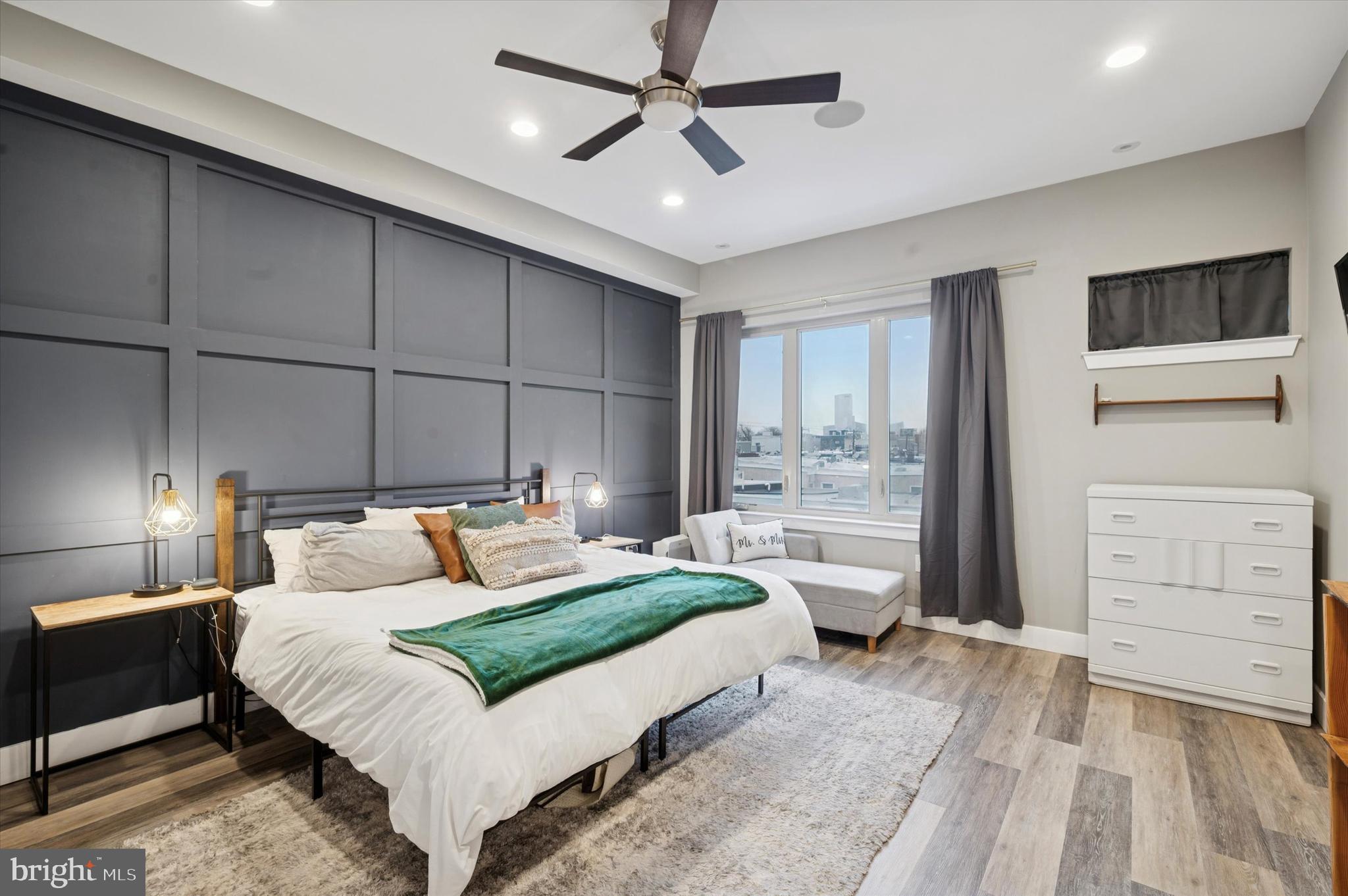 1942 Tasker Street Philadelphia, PA 19145 - Photo 15 of 35 a bedroom with a large bed a chandelier and dresser
