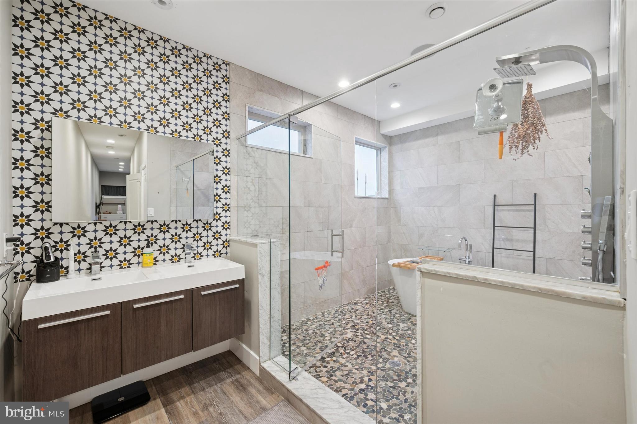 1942 Tasker Street Philadelphia, PA 19145 - Photo 17 of 35 a bathroom with a sink mirror and shower