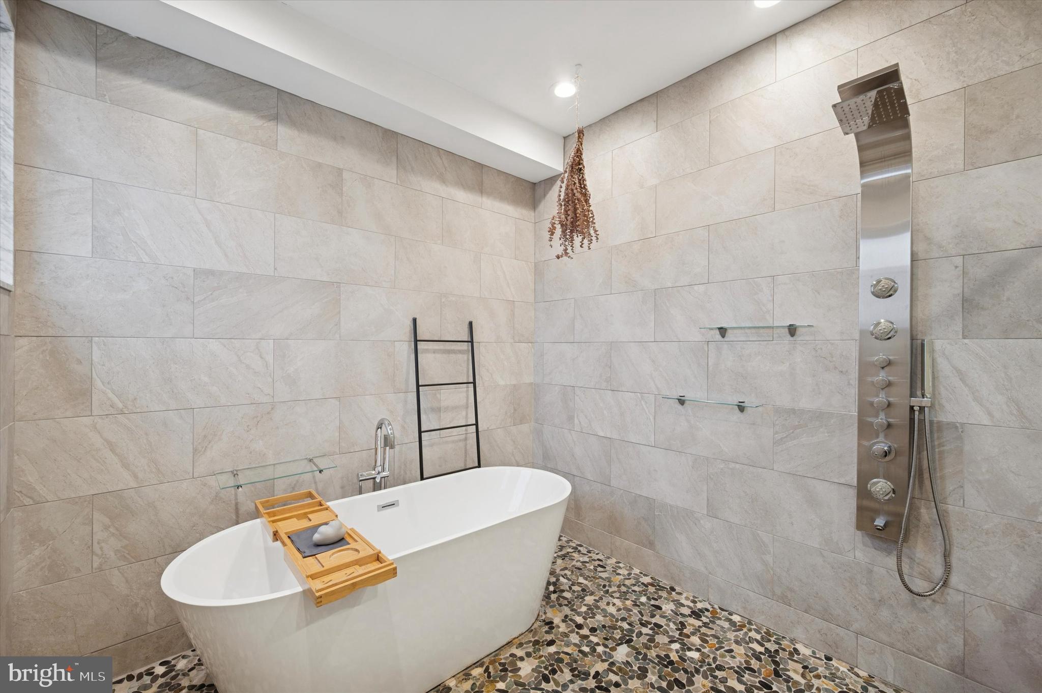 1942 Tasker Street Philadelphia, PA 19145 - Photo 18 of 35 a bathroom with a bathtub and a shower