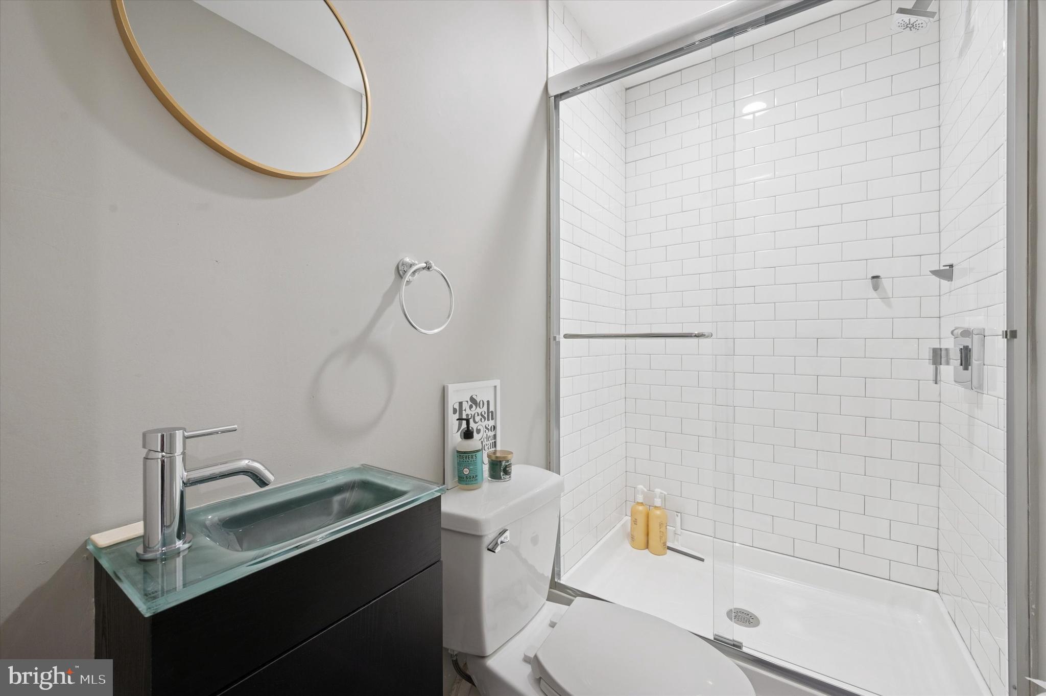 1942 Tasker Street Philadelphia, PA 19145 - Photo 28 of 35 a bathroom with a sink a toilet and shower