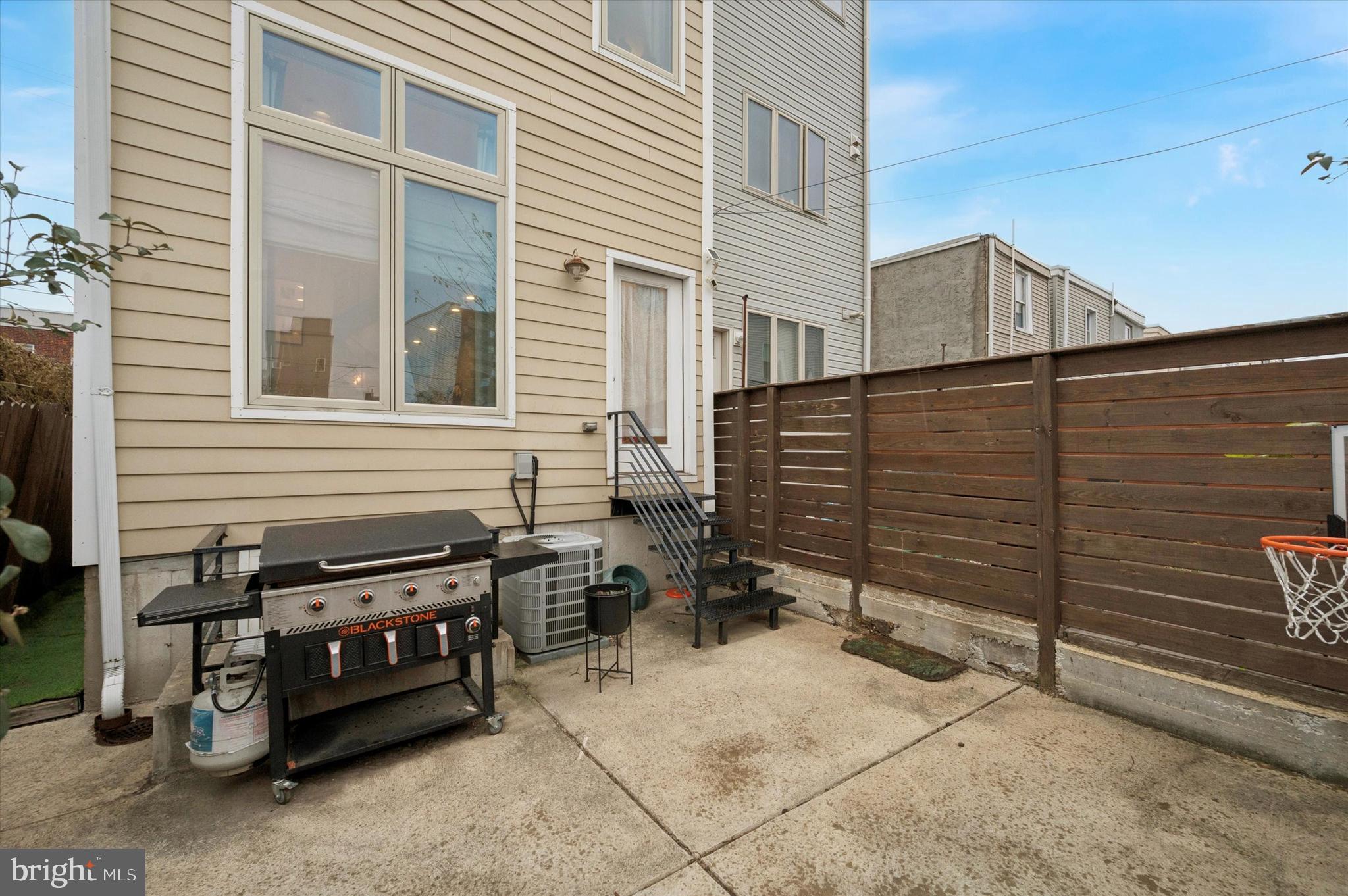 1942 Tasker Street Philadelphia, PA 19145 - Photo 31 of 35 a view of a house with a barbeque and wooden stairs