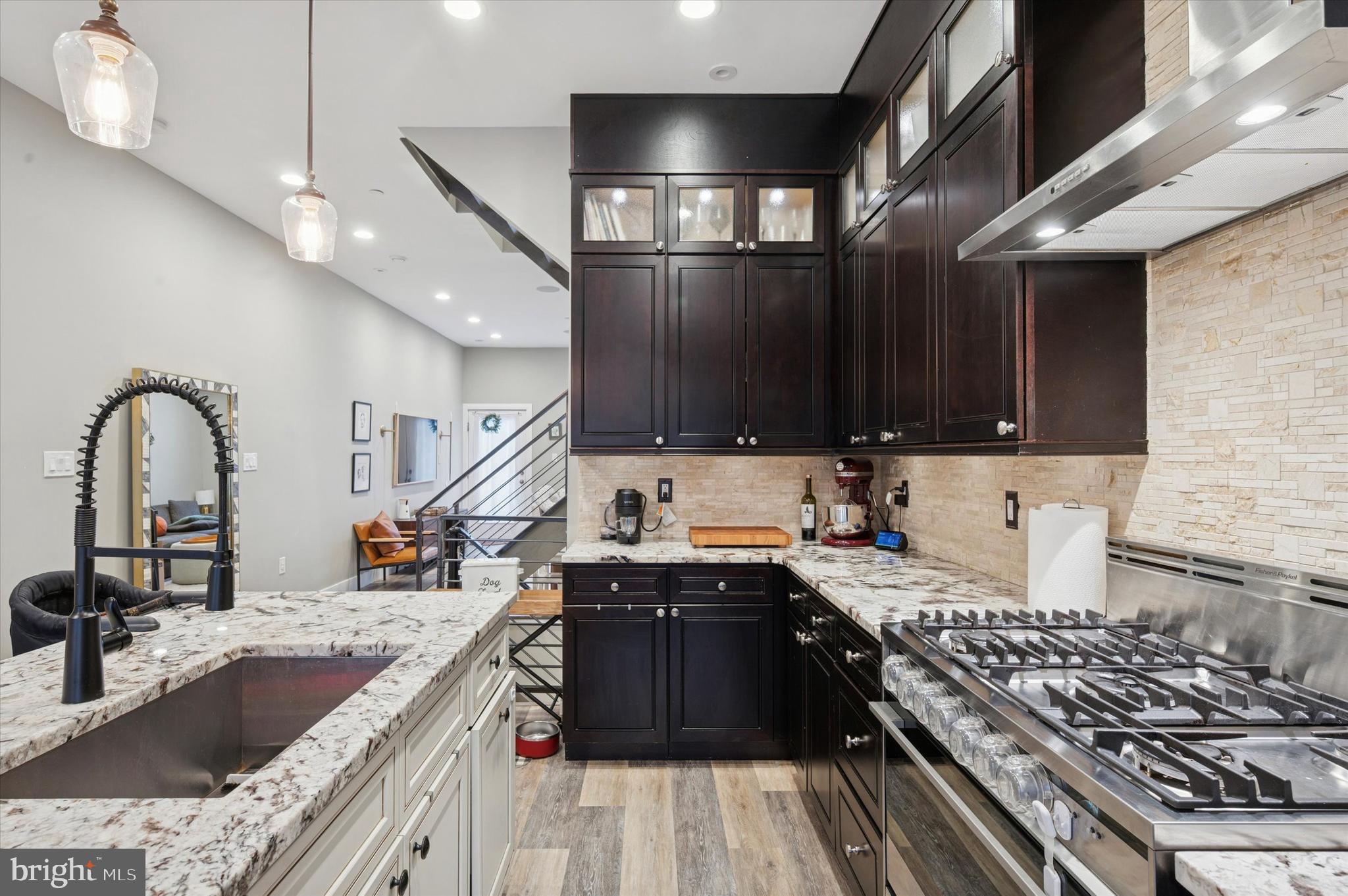 1942 Tasker Street Philadelphia, PA 19145 - Photo 4 of 35 a kitchen with stainless steel appliances granite countertop a sink stove and cabinets