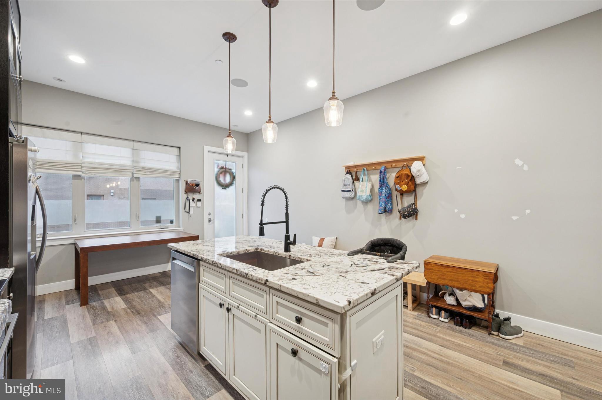 1942 Tasker Street Philadelphia, PA 19145 - Photo 6 of 35 a kitchen with a sink cabinets and wooden floor