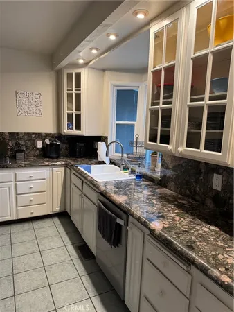a kitchen with a sink and wooden floor