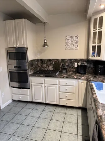 a bed sitting in a room next to a lamp