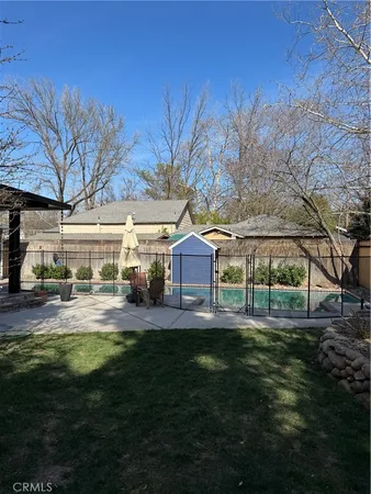 a view of a room with chairs and wooden floor