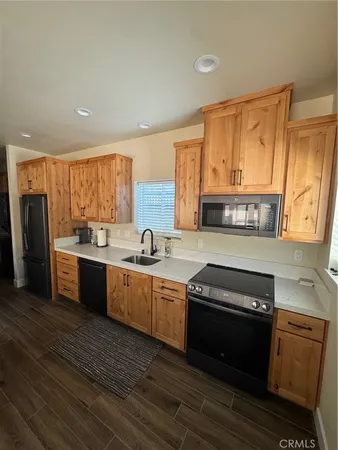 a kitchen with stainless steel appliances granite countertop a sink and a stove