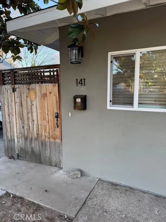 a kitchen with white cabinets and appliances