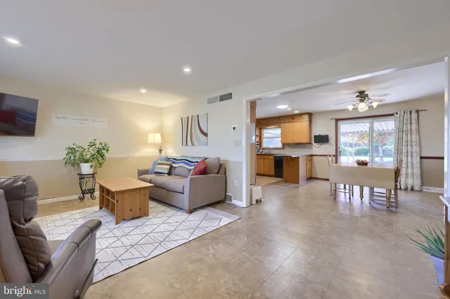 a view of a dining room with furniture and a chandelier