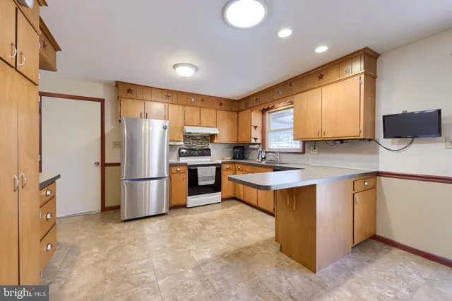 a kitchen with stainless steel appliances a refrigerator and a stove