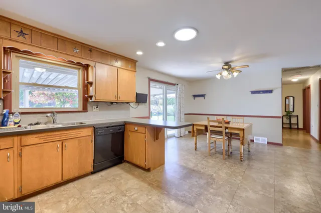 a kitchen with a sink cabinets and window