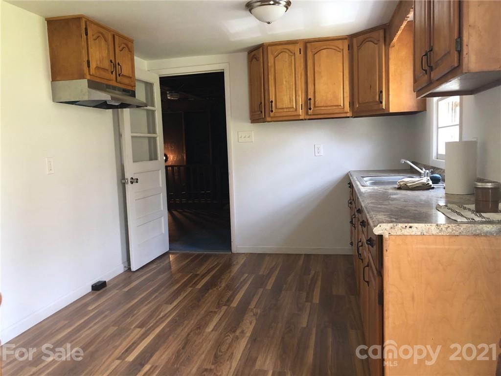 289 Long Branch Road Clyde, NC 28721 - Photo 12 of 44 a kitchen with a refrigerator and cabinets