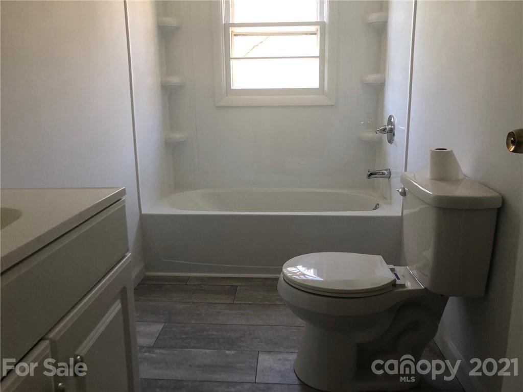 289 Long Branch Road Clyde, NC 28721 - Photo 14 of 44 a bathroom with a toilet and a bathtub